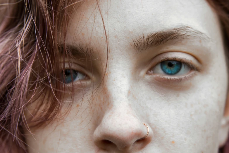 a girl with freckles on her face and blue eyes