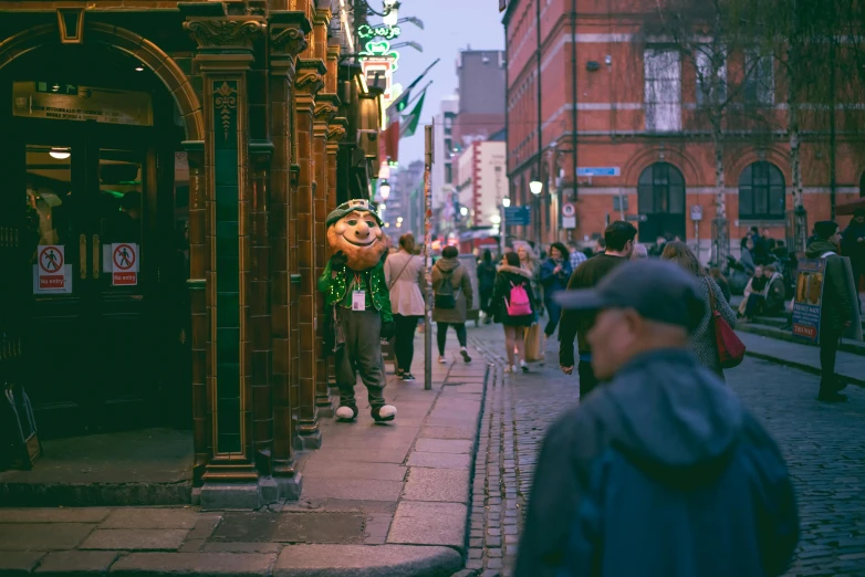 people walking around in a city street next to buildings