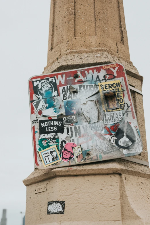 a box on top of a pillar with graffiti