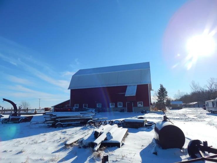 a barn is surrounded by snow with two water meters on it