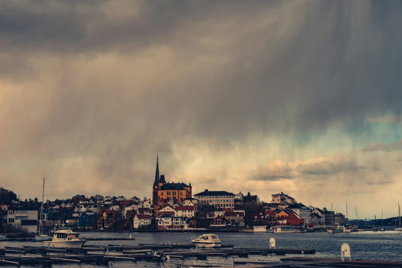 some boats docked in a bay under a cloudy sky