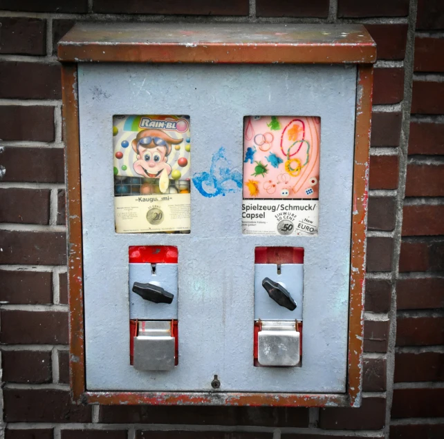 there are two cell phones next to a brick wall