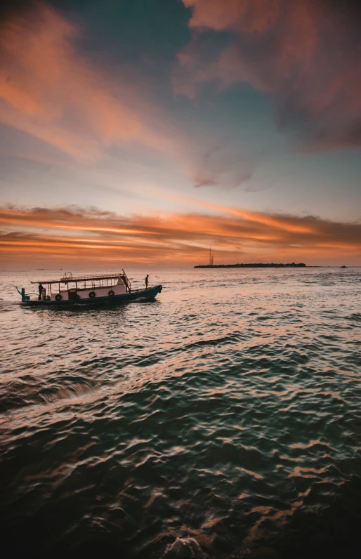 a small boat sailing across a large body of water