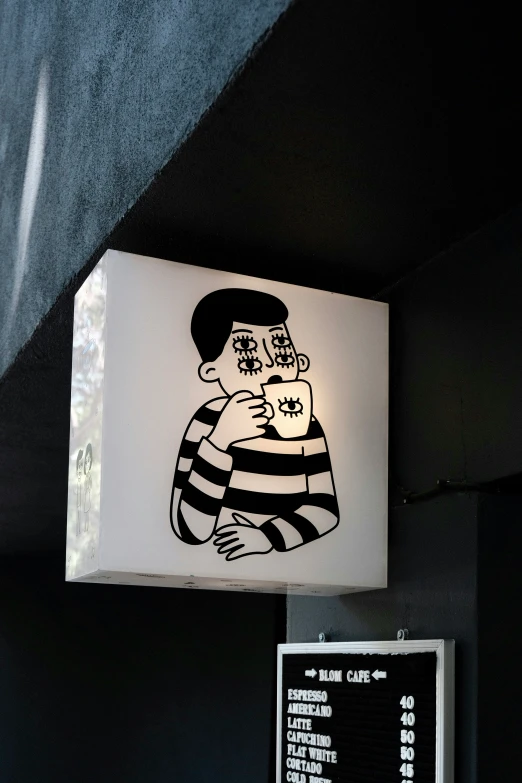a wall mounted sign that is displaying a cartoon image