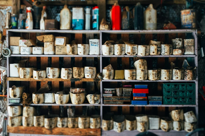 an assortment of cheeses and bottles with stacks of boxes