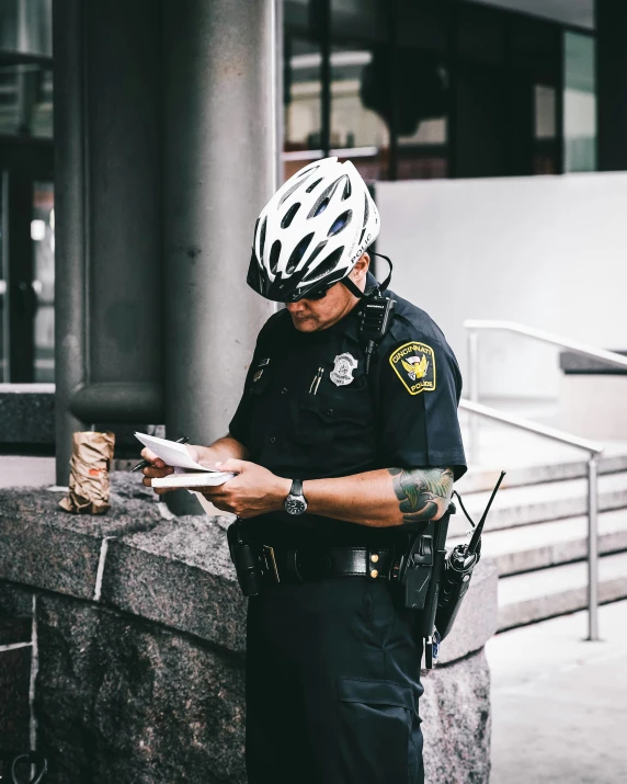 a man in a helmet and a bike shirt is looking at soing