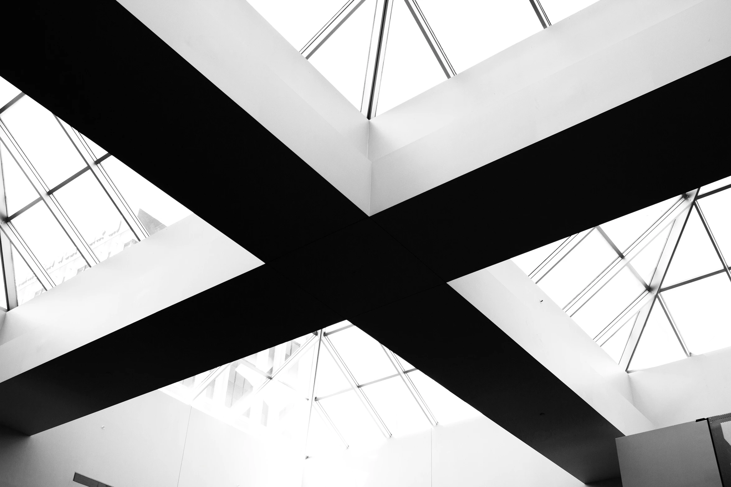 black and white image of a ceiling with windows