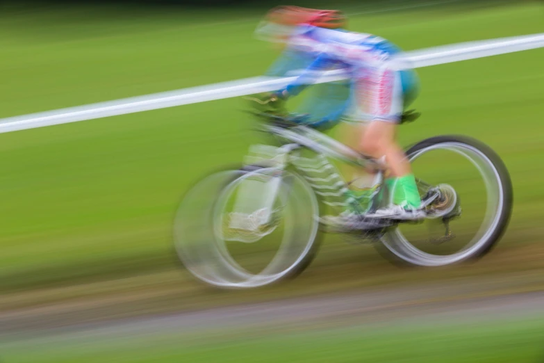 a blurry po of a cyclist in action