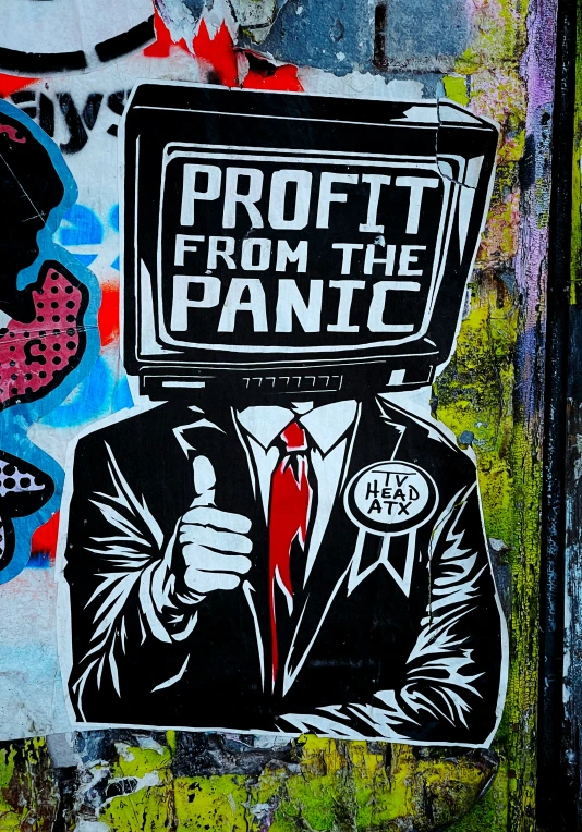 the graffiti is depicting a man wearing a suit and holding a television