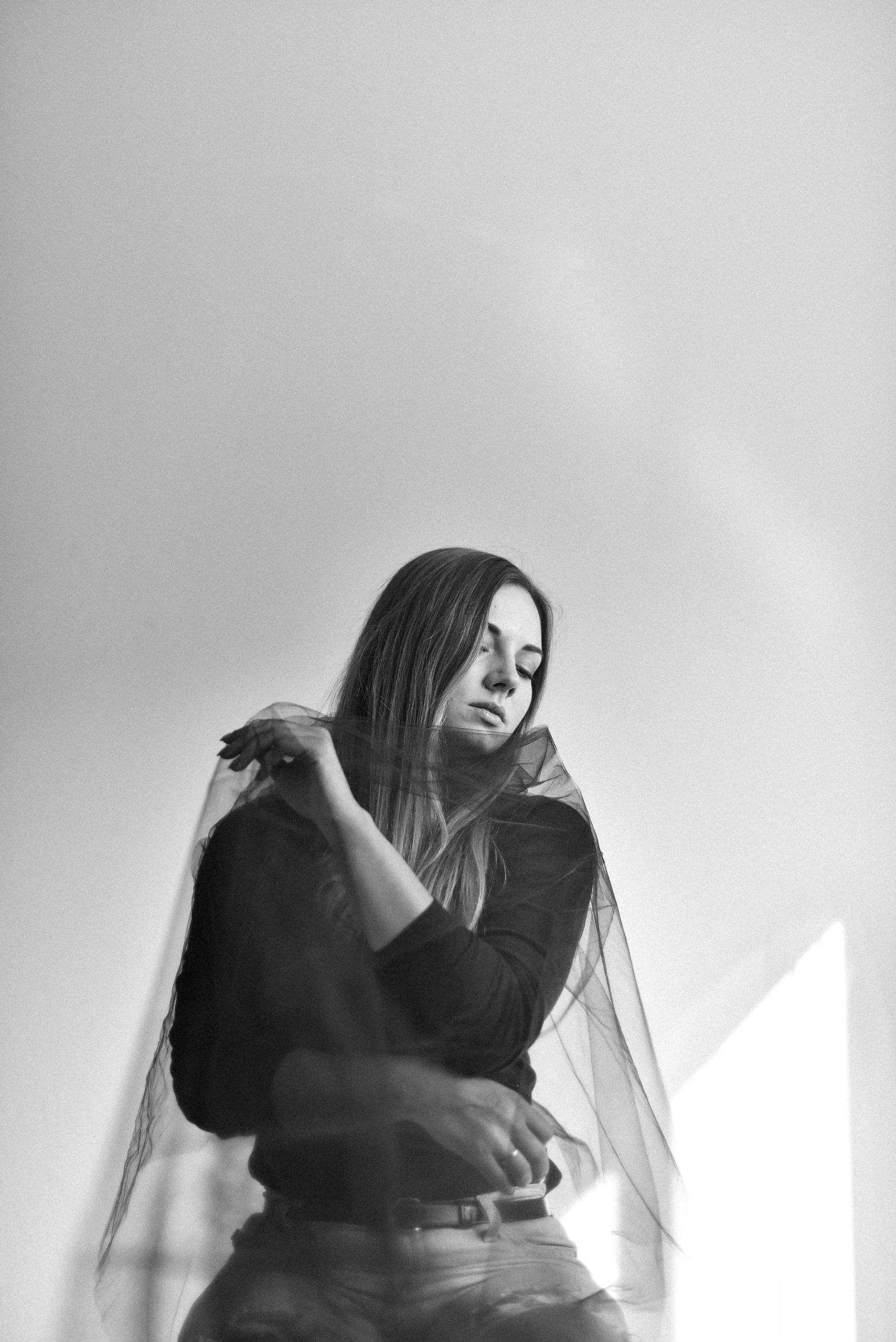 a bride sits on a staircase wearing a veil