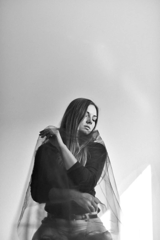 a bride sits on a staircase wearing a veil