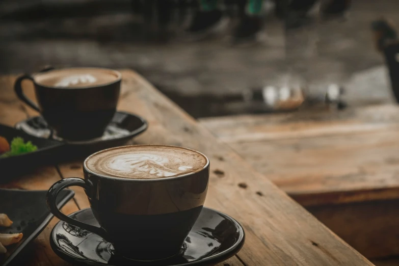 two cups are shown sitting on plates