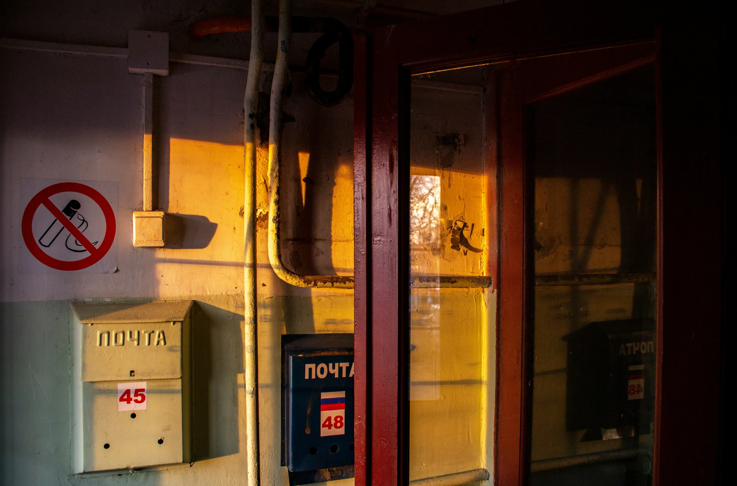 the window to a bus with no smoking signs