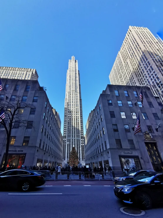 view of the side of tall buildings looking up at street signs