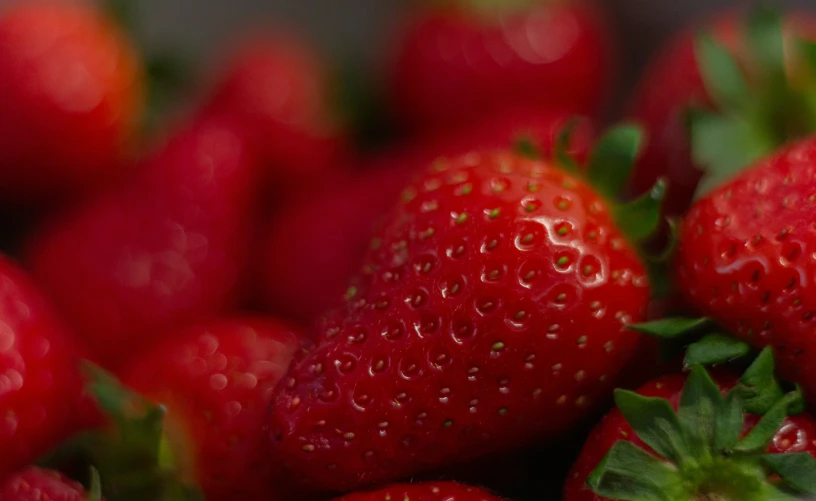 a bunch of red strawberries are next to each other