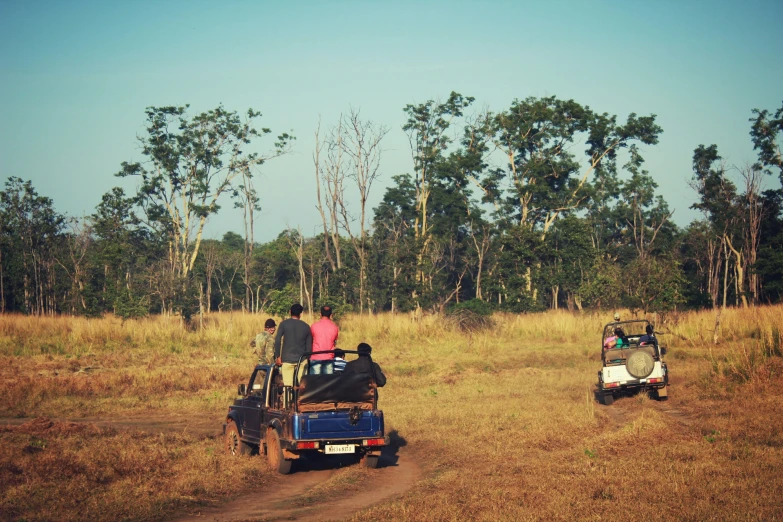 a few people riding on the back of vehicles