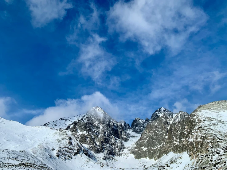 some very tall snow covered mountains in the background