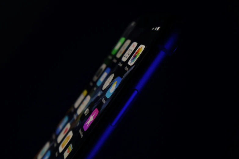 a close up of a cellphone in the dark
