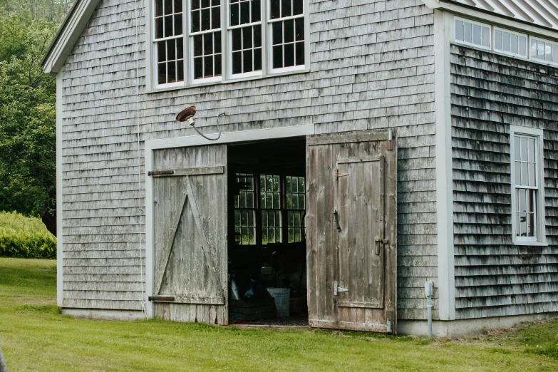 a very old looking gray building with big windows