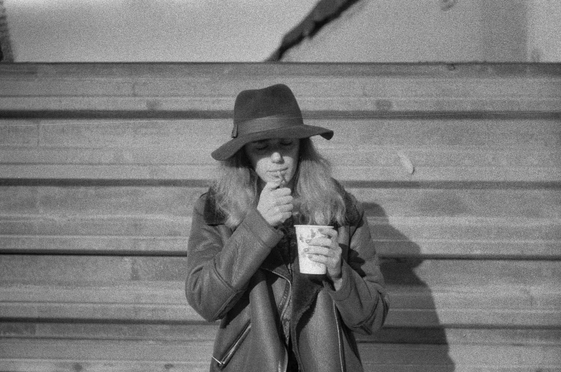 a black and white po of a woman drinking