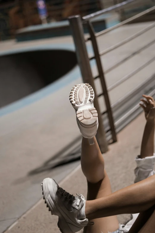 a person laying on the ground with their foot in the air