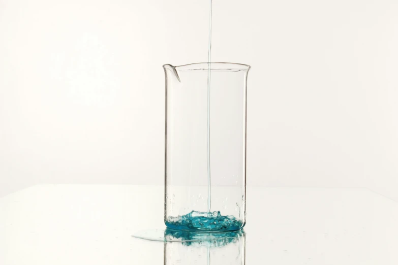 the water is pouring into the glass vase