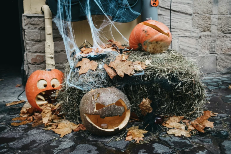 pumpkins that are sitting on some hay