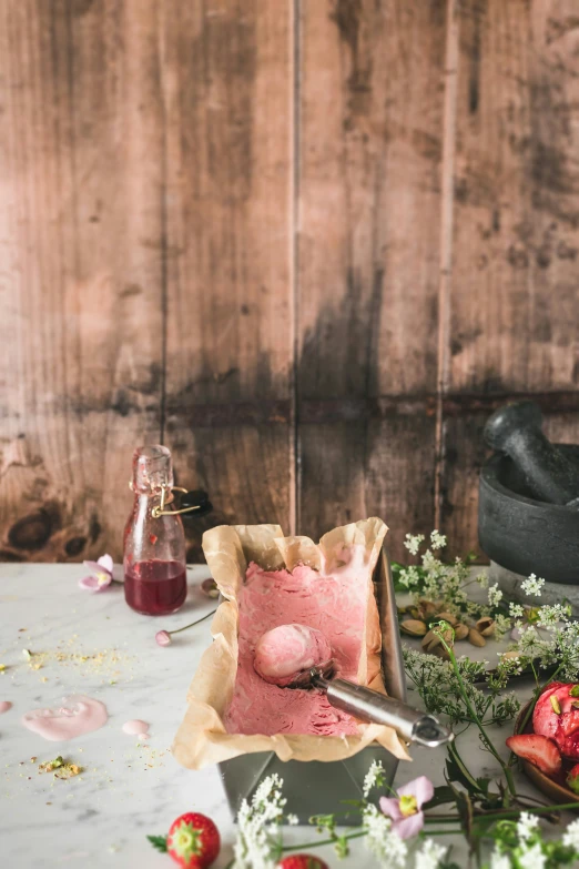 a table filled with fresh fruit and food next to a wooden wall