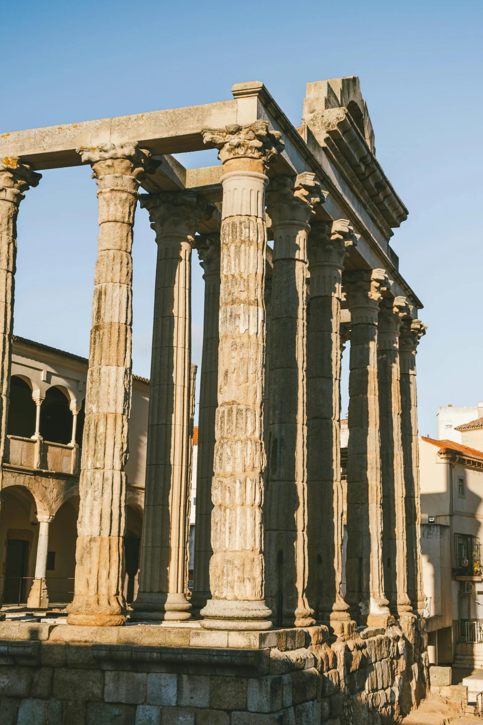 the large roman ruins are next to a building