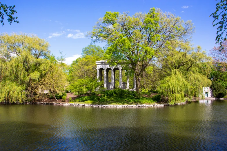 a pavilion is on an island next to the water