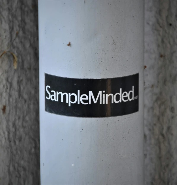 a sticker sitting on the side of a metal pole