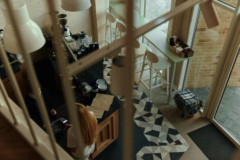 a girl looking through a window in her apartment