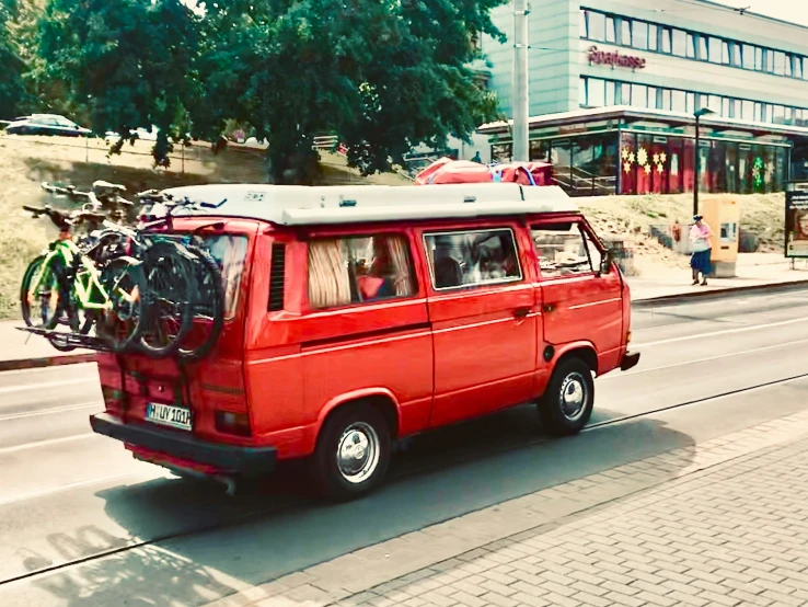 there is a red van parked on the street