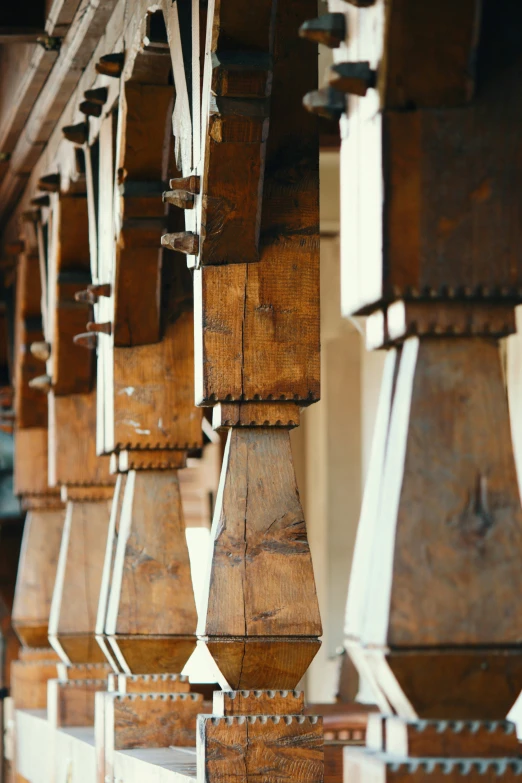 a wooden clock on a pole in a building