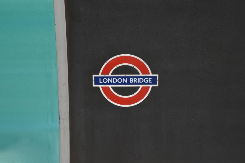 a sign on the side of a building that reads london bridge