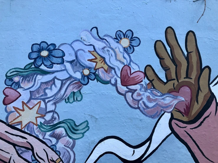 painted hand and star on wall on street