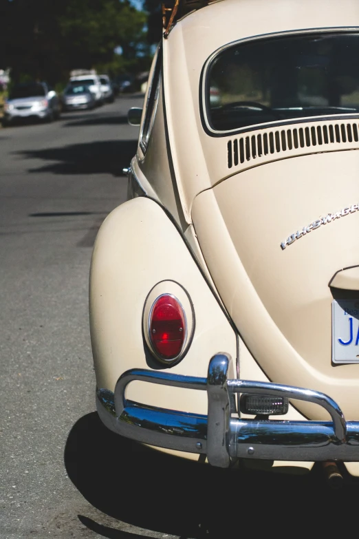 an old beetle sitting on the side of a road