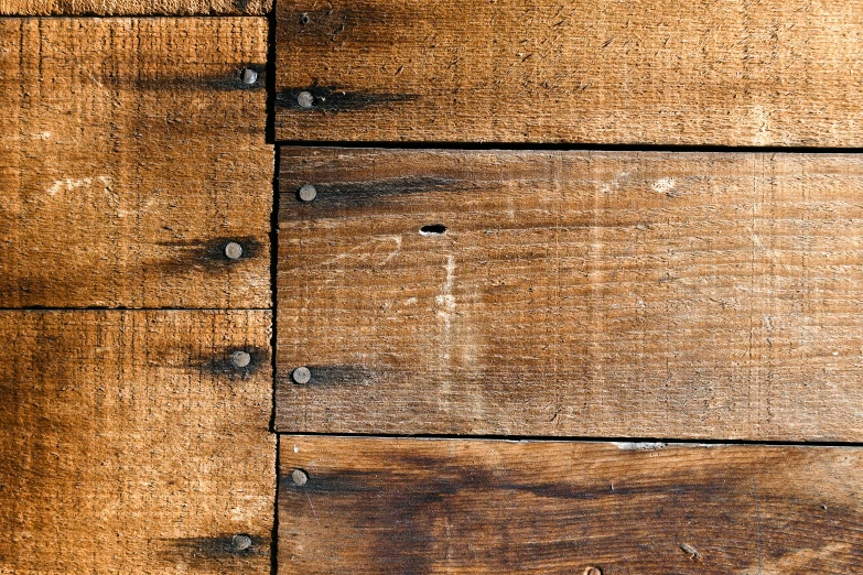 the wood surface is brown with many rivets
