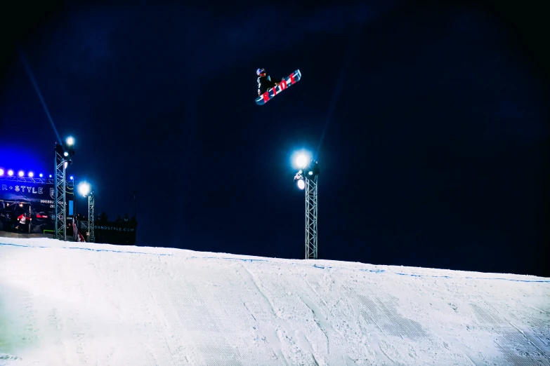 the man is skiing downhill under street lights