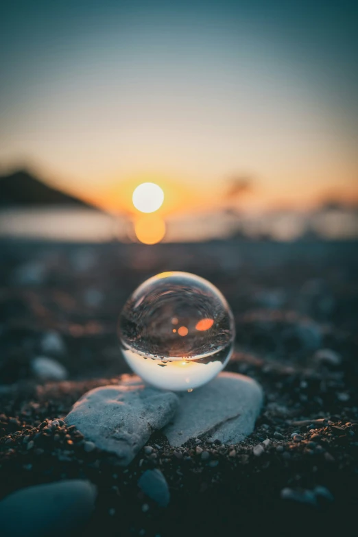 there is a crystal ball on the ground near rocks