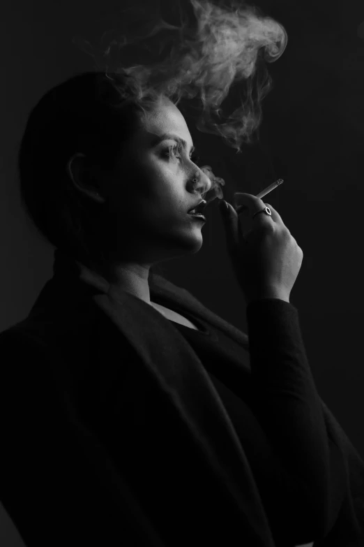 a woman holding a cigarette, looking back at her