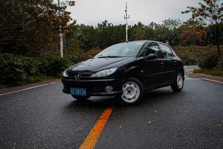 a black car driving down a curvy city street