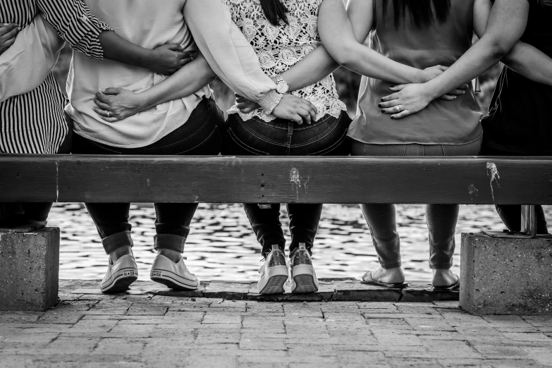 a group of people sitting on top of a bench