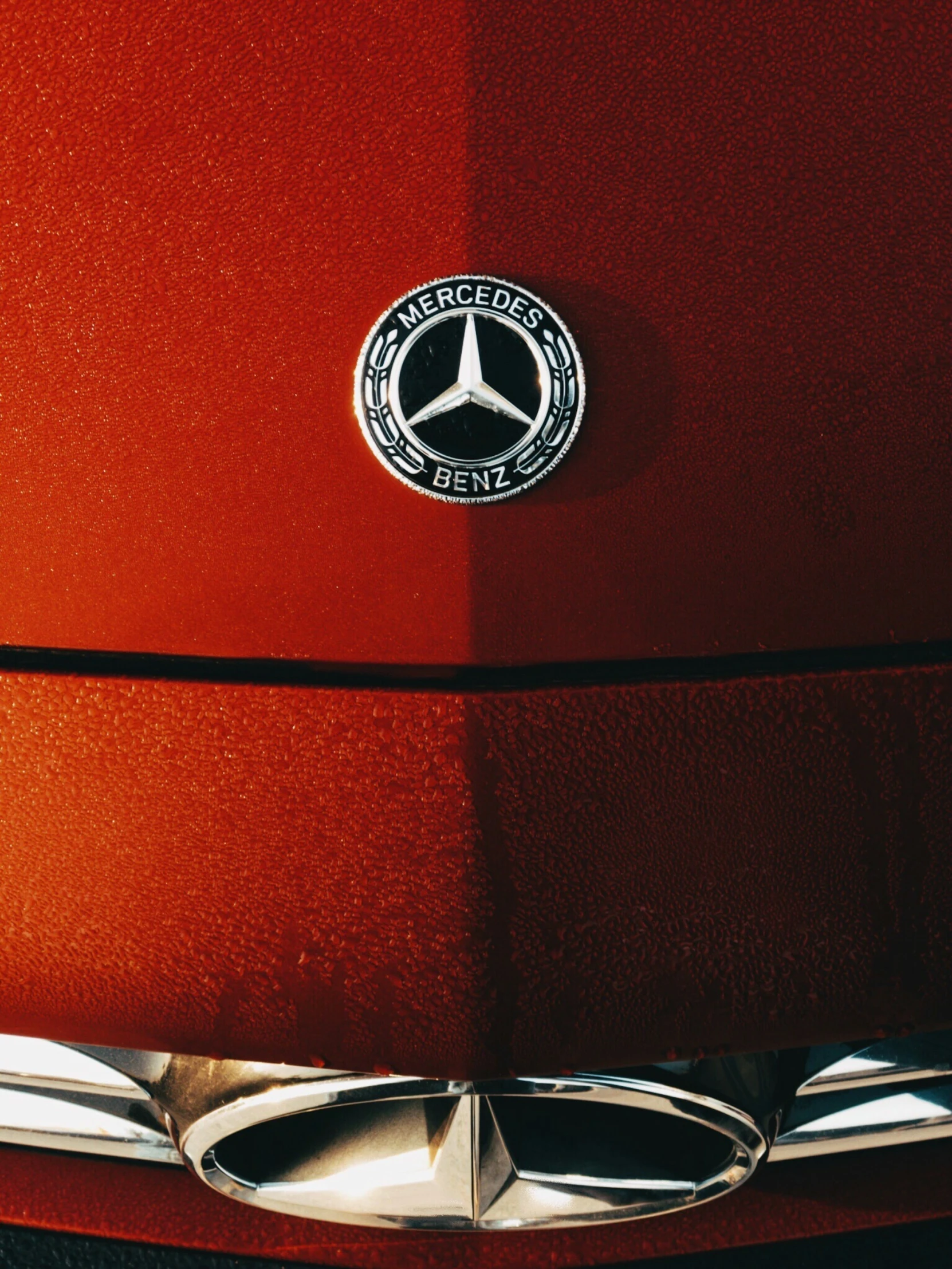 closeup on the emblem of a red car