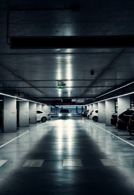 a parking garage has two lanes full of parked cars