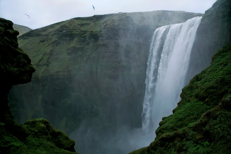 view of a waterfall with a single person standing on it