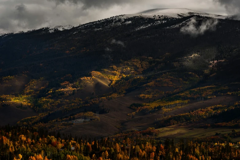 an airplane flying over some mountains on a cloudy day