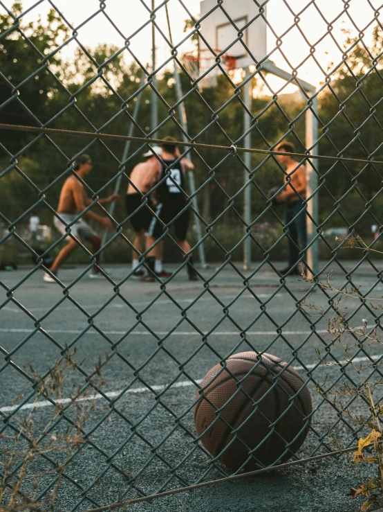 a basketball is sitting on the ground next to some players