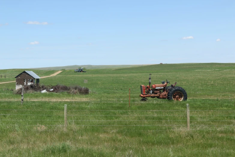 an old farm tractor in a grassy field