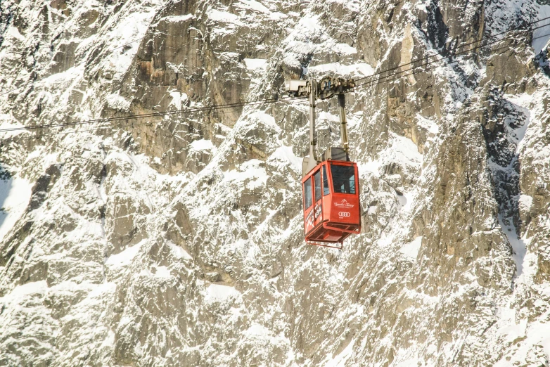 a red chair lift is in the snow